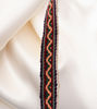 Colorful stackable bracelet on white fabric, crafted from Peruvian manta with intricate Inca designs, perfect for boho style.
