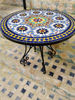 A vibrant mosaic coffee table on a patio, featuring intricate geometric designs, ideal for enhancing indoor and outdoor spaces.