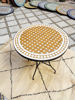 Gold and white round mosaic coffee table featuring intricate patterns, showcasing Moroccan artistry for indoor and outdoor use.