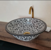 Handcrafted black and white ceramic sink with gold details, reflecting Moroccan artistry and perfect for stylish bathroom decor.