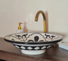 A black and white bowl placed on a kitchen counter, showcasing its simple design against the countertop's surface.