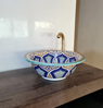Customizable Moroccan sink with a gold faucet, showcasing a vibrant blue and white mandala pattern on ceramic.