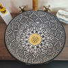 Black and white ceramic wash basin with a gold faucet, featuring unique hand-painted designs inspired by Moroccan artistry.