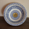 Hand-painted blue and white ceramic sink with a gold handle, showcasing intricate Moroccan designs for elegant bathroom decor.