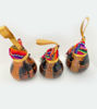 Set of three colorful wooden ornaments, handmade by Peruvian artisans, showcasing intricate designs inspired by ancient techniques.