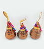 Three unique wooden ornaments with vibrant patterns, crafted by Peruvian artisans using traditional methods from the Colonial Period.