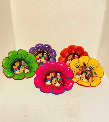 Colorful flower-shaped dishes feature hand-painted figures in a vintage Peruvian nativity scene, showcasing Andean craftsmanship.