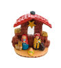 Handcrafted mini ethnic nativity scene with ceramic Holy Family figurines in a folk art style.