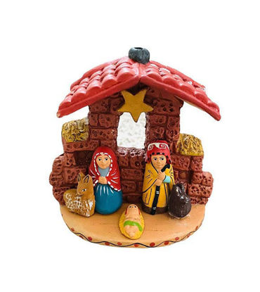Handcrafted mini ethnic nativity scene with ceramic Holy Family figurines in a folk art style.