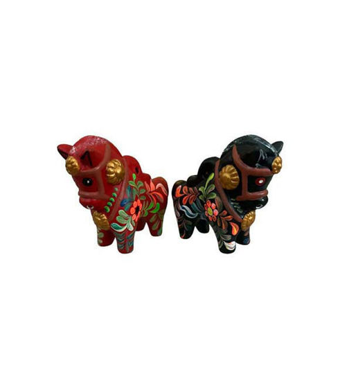 Two colorful wooden horses, handcrafted in Peru, symbolizing strength and tradition in terracotta folk art.