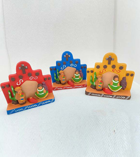 Three handcrafted ceramic figurines of the Holy Family, symbolizing cultural heritage, displayed on a white surface.