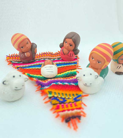 Tiny handmade nativity scene featuring the Holy Family and Three Kings, crafted from clay and hand-painted by Peruvian artisans.
