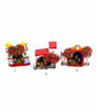 Three handcrafted clay houses with red roofs, showcasing a vintage nativity scene with charming pompom embellishments.