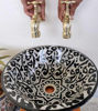 Handmade black and white ceramic sink with gold faucets, highlighting its Moroccan design and elegance.