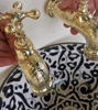 Ceramic basin with unlacquered brass faucets, emphasizing its artisanal Moroccan style.