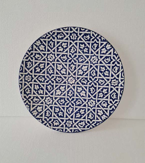 A 14-inch blue and white Moroccan ceramic wall plate featuring intricate geometric designs, showcasing traditional craftsmanship.