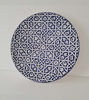 Handmade 14-inch Moroccan ceramic plate in blue and white, displaying detailed geometric patterns, perfect for wall decor.
