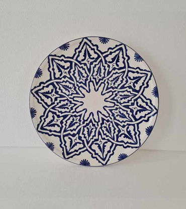 A 14-inch handmade Moroccan ceramic plate in blue and white, featuring intricate hand-painted designs and a glossy finish.