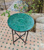 Custom emerald green Zellige table on a patio, featuring a black metal frame and intricate tile design, perfect for outdoor use.