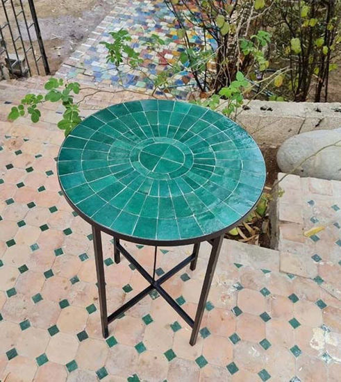 Custom emerald green Zellige table on a patio, featuring a black metal frame and intricate tile design, perfect for outdoor use.