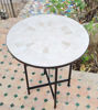 Mid-century modern Zellige table with a black metal frame, set on a patio, showcasing Moroccan craftsmanship.
