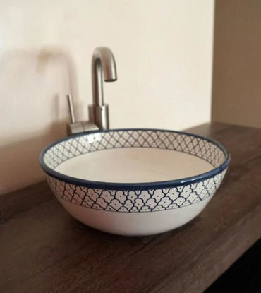 Handcrafted blue and white ceramic washbasin with intricate patterns, showcasing Mediterranean charm and artisan craftsmanship.