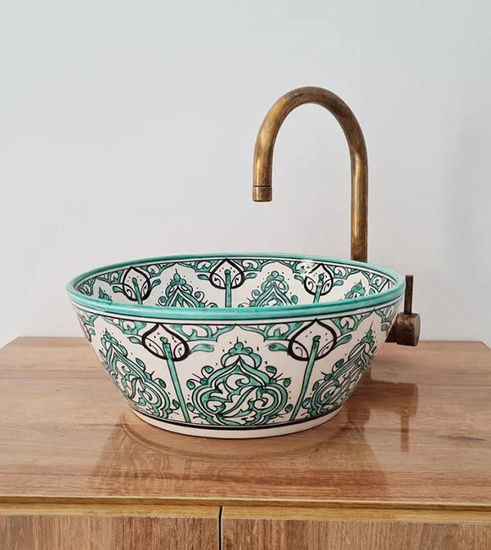 Hand-painted ceramic sink with a green and white design, featuring a unique bucket shape inspired by Moroccan artistry.