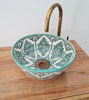 Mid-century modern ceramic sink with a green and white pattern, showcasing a handcrafted bucket shape from Moroccan artisans.