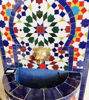 Colorful mosaic tile wall fountain on a stand, showcasing intricate Moroccan patterns