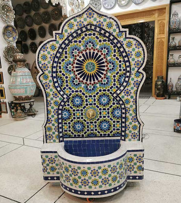 Colorful Moroccan mosaic fountain with floral patterns, showcasing vibrant artistry and calming water flow in a store setting.