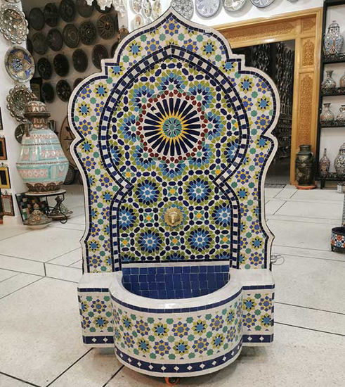 Colorful Moroccan mosaic fountain with floral patterns, showcasing vibrant artistry and calming water flow in a store setting.