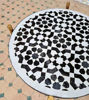 Elegant black and white mosaic table, handcrafted in Morocco, ideal for adding style to any space.