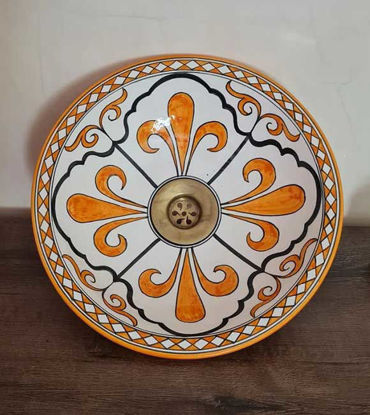 Decorative orange and white ceramic bowl with a brass rim, showcasing Moroccan craftsmanship and vibrant hand-painted design.
