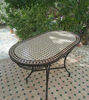 Elegant oval Moroccan mosaic table crafted from Zellige tiles, suitable for both indoor and outdoor settings.