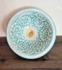 Handpainted ceramic sink with a turquoise fish scales design, showcasing Bohemian style and Moroccan craftsmanship.
