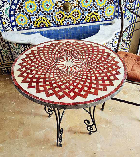 Round outdoor coffee table with a vibrant red Zellige mosaic design, showcasing intricate patterns and Moroccan craftsmanship.