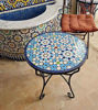 Vibrant blue mosaic tile on a round table, highlighting traditional Moroccan artistry and intricate geometric designs.