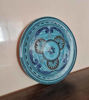 Elegant blue and white ceramic plate set, handcrafted in Morocco, highlighting unique designs and durable construction for dining.
