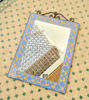 Light blue Moroccan mosaic mirror on a tiled floor, showcasing intricate geometric patterns and handcrafted artistry.