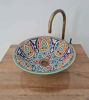Vibrant ceramic washbasin featuring detailed Moroccan artistry and a brass faucet, perfect for bathroom or kitchen decor.