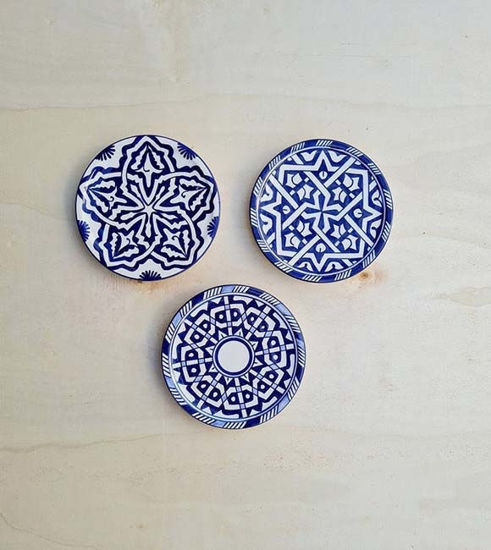 Set of three blue and white ceramic plates featuring unique designs, reflecting traditional Moroccan pottery artistry.