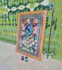 Vibrant peacock mosaic wall art on the floor, featuring over 300 handcrafted ceramic tiles in rich colors.