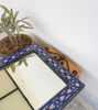 Elegant Moroccan mosaic mirror with blue and white patterns, handcrafted for versatile indoor and outdoor decor.
