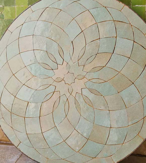 Circular tile table featuring a handcrafted flower design, showcasing Moroccan Zellige artistry in natural sage tones.