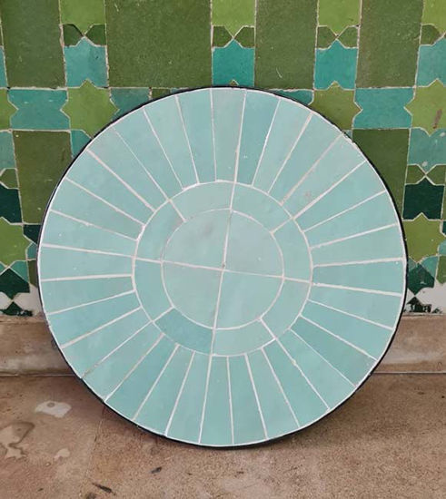 Vibrant turquoise tile table with a circular mosaic design, perfect for indoor or outdoor decor, reflecting Moroccan artistry.