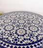 Close-up of a blue and white geometric tile table, showcasing intricate patterns and Moroccan design for indoor and outdoor use.