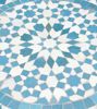 Detailed view of a blue and white mosaic table, handcrafted in turquoise, perfect for bistro settings on a patio.