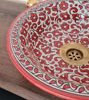 Vibrant red and white ceramic sink with a gold handle, highlighting mid-century modern style and intricate floral motifs.