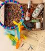 A ritual kit box containing a dream catcher, crystal, sage bundle, essence etc. designed for energy cleansing and inner peace.