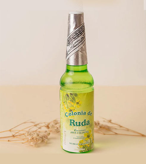 A bottle of Rue Cologne with dried flowers, representing natural cleansing and spiritual protection for abundance and love.